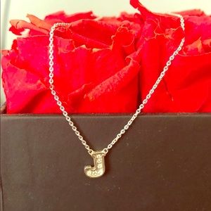 Diamond J pendant on a white 14k gold chain.